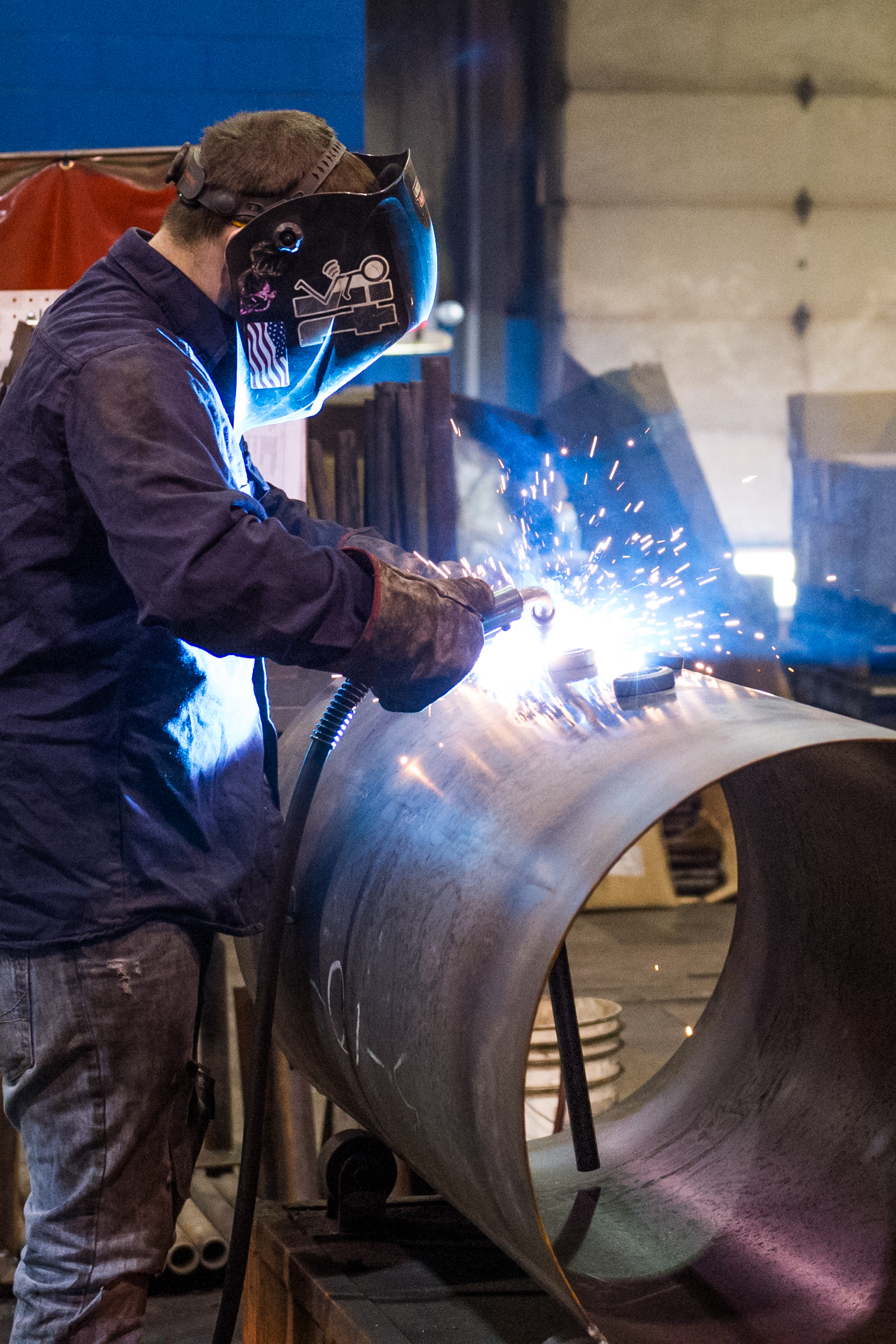 worker with blow torch working on a manufacturing project