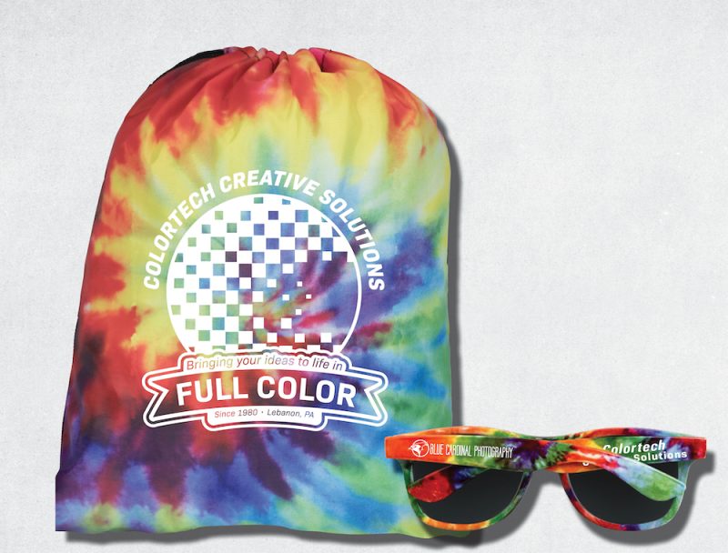 Colortech promotional items: a tie-dye drawstring bag and a pair of tie-dye sunglasses.